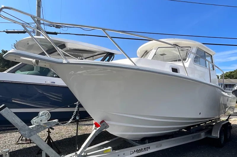 The Image of 2026 NorthCoast 255 HT boat on trailer under clear blue sky. - 1