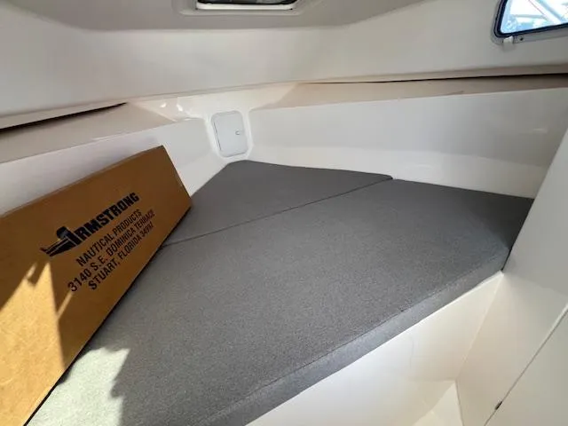 Slide: The Image of Interior cabin of 2026 NorthCoast 255 HT boat with gray cushions. - 10