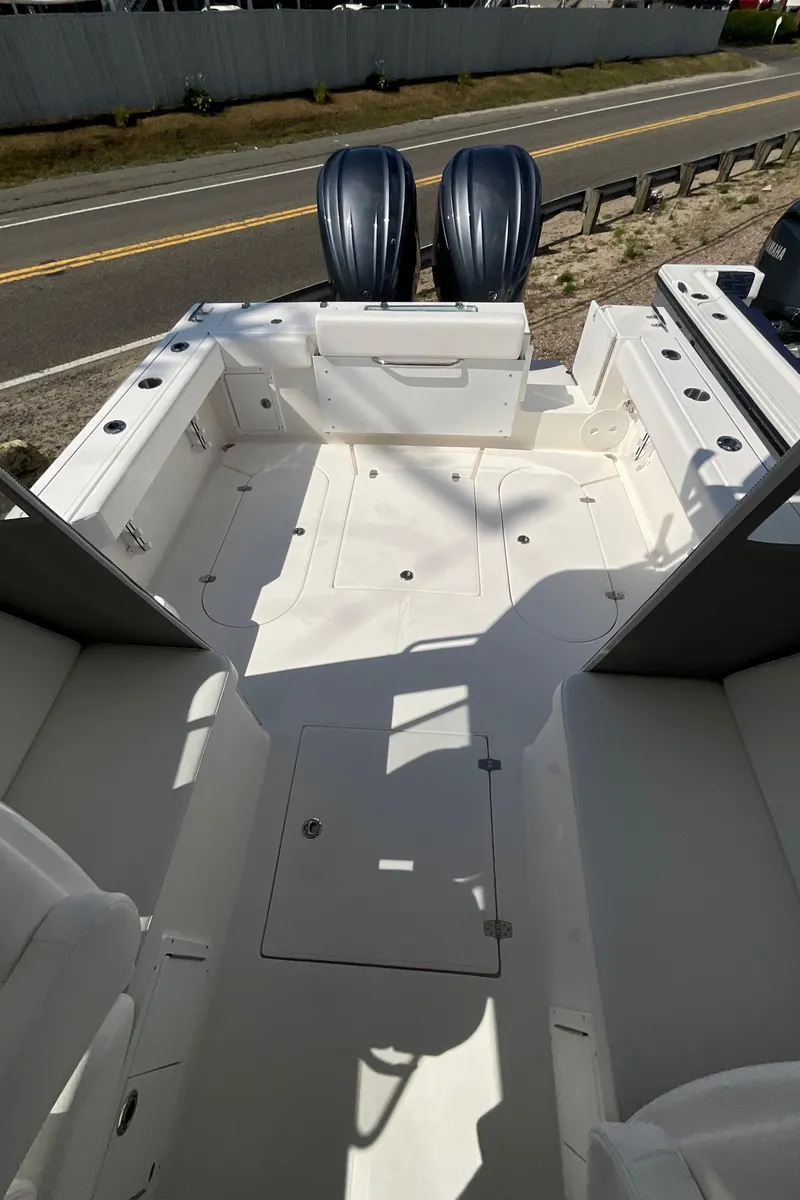 Slide: The Image of 2026 NorthCoast 255 HT boat interior with dual engines, spacious deck, and seating. - 2