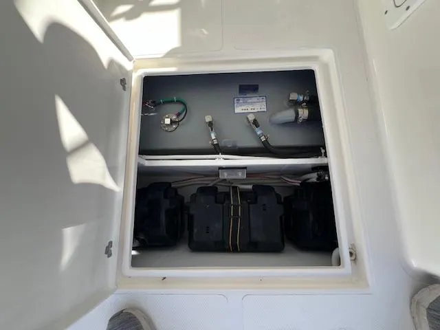 Slide: The Image of Battery compartment of 2026 NorthCoast 255 HT boat, showing wiring and components. - 8