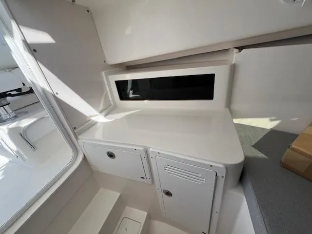 Slide: The Image of Interior cabin of 2026 NorthCoast 255 HT boat, featuring storage compartments. - 9