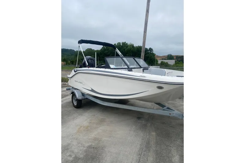 The Image of 2025 Bayliner Element M17 boat on trailer, parked outdoors on a cloudy day. - 0