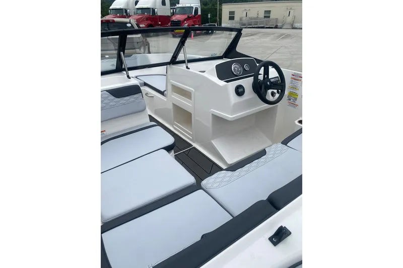 Slide: The Image of 2025 Bayliner Element M17 boat interior with modern seating and steering console. - 10