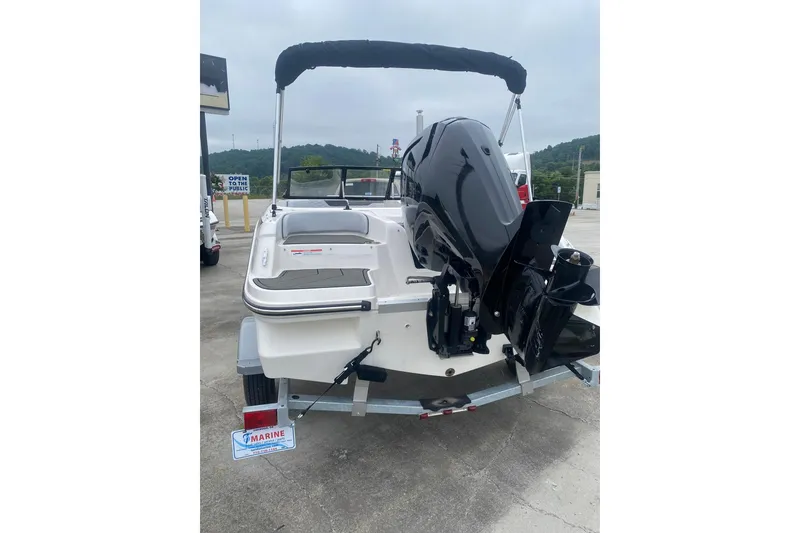 Slide: The Image of 2025 Bayliner Element M17 boat, rear view with outboard motor, parked on trailer. - 3