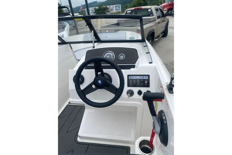 Slide: The Image of 2025 Bayliner Element M17 boat dashboard with steering wheel and controls. - 8