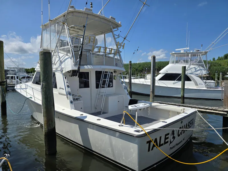 Slide: The Image of 1998 Henriques 38 Sportfisherman docked at marina under clear blue sky. - 1