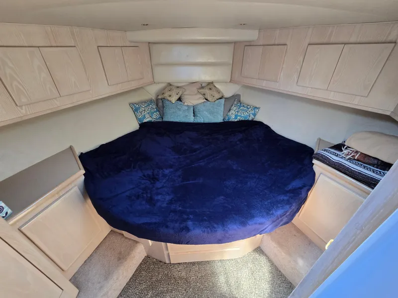 Slide: The Image of Cozy cabin interior of 1998 Henriques 38 Sportfisherman with plush bedding and storage cabinets. - 15
