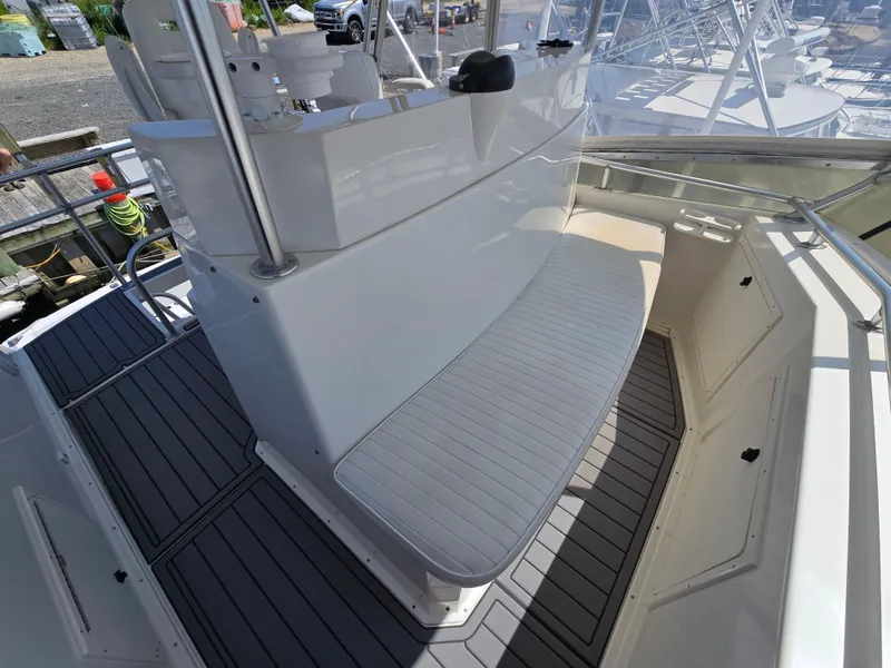 Slide: The Image of 1998 Henriques 38 Sportfisherman boat deck with seating and storage compartments. - 18