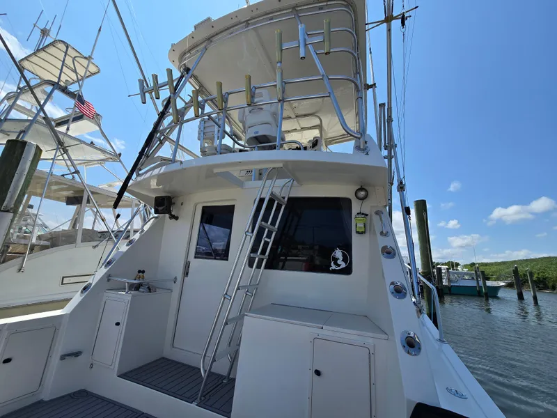 Slide: The Image of 1998 Henriques 38 Sportfisherman boat docked under clear blue sky. - 4