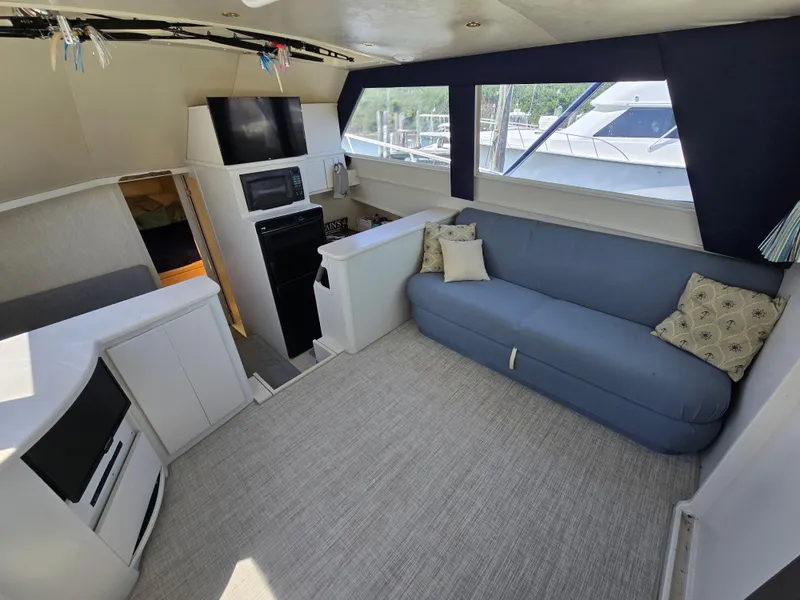 Slide: The Image of Interior of a 1998 Henriques 38 Sportfisherman with blue sofa and modern amenities. - 8