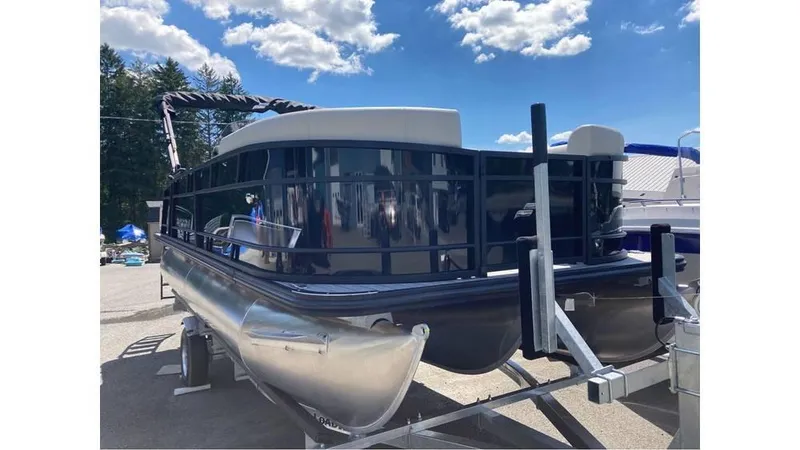 Slide: The Image of 2025 Starcraft EXS 1 Q DH pontoon boat on trailer under blue sky. - 4