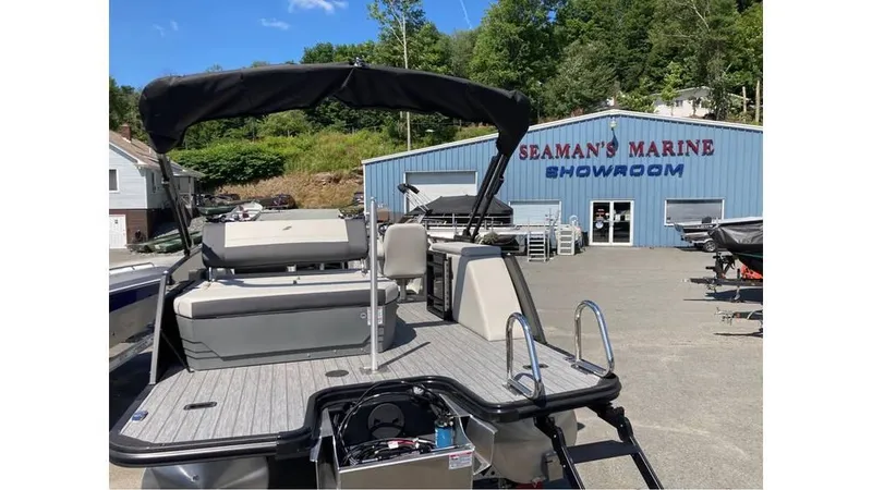 Slide: The Image of 2025 Starcraft EXS 1 Q DH boat at Seaman's Marine showroom, sunny day. - 8