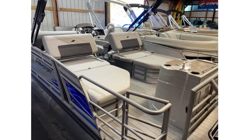 Slide: The Image of 2025 Starcraft CX 23 RL pontoon boat interior with seating and helm. - 5