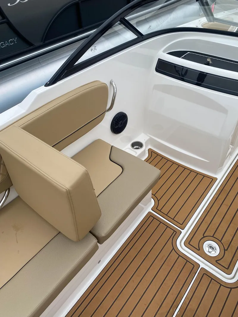Slide: The Image of 2025 Bayliner VR4 Bowrider OB interior with tan seating and teak-style flooring. - 16