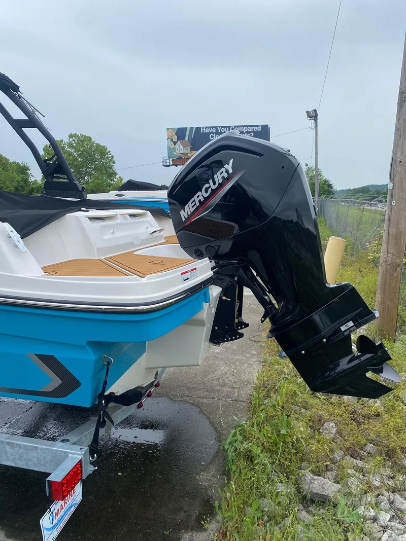Slide: The Image of 2025 Bayliner VR4 Bowrider OB with Mercury outboard motor, parked on a trailer. - 3