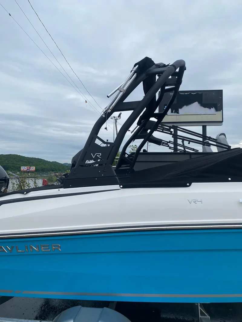 Slide: The Image of 2025 Bayliner VR4 Bowrider OB with sleek design and vibrant blue hull. - 4