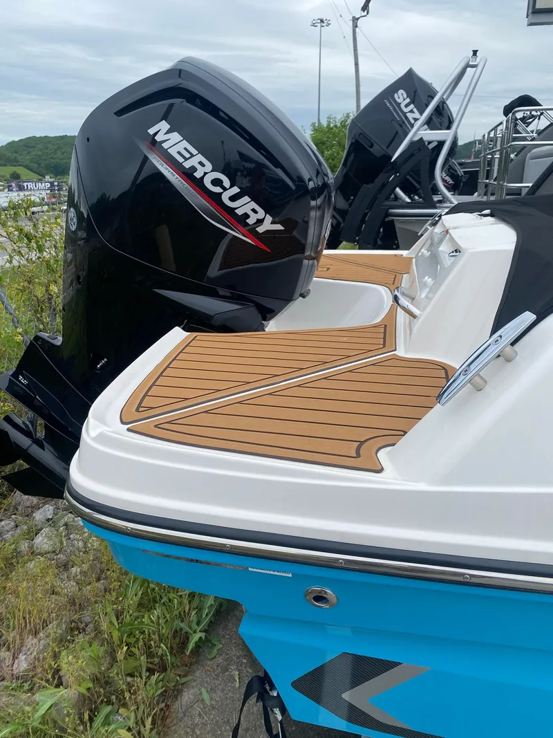 Slide: The Image of 2025 Bayliner VR4 Bowrider OB with Mercury outboard motor, featuring sleek design and wood-style deck. - 7