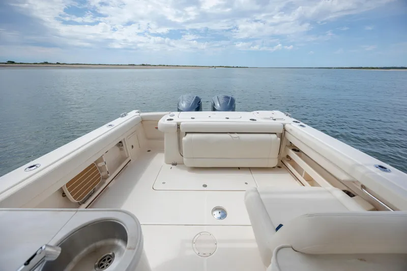 Slide: The Image of 2020 Grady-White Freedom 307 boat deck with ocean view and dual engines. - 10