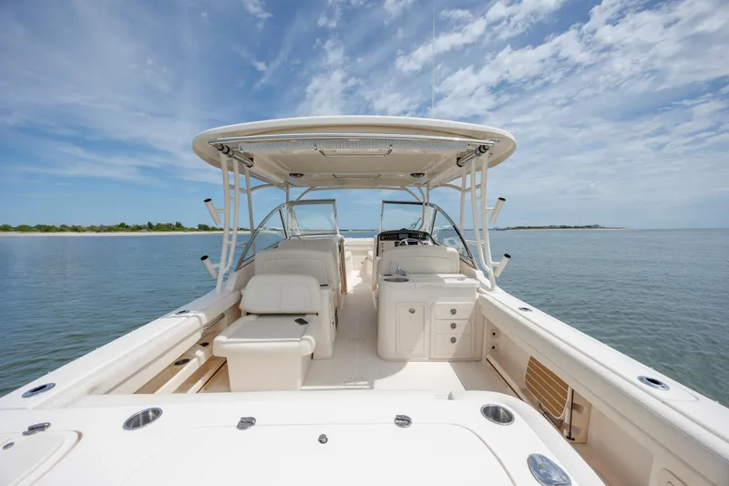 Slide: The Image of 2020 Grady-White Freedom 307 boat on calm water under a clear blue sky. - 12