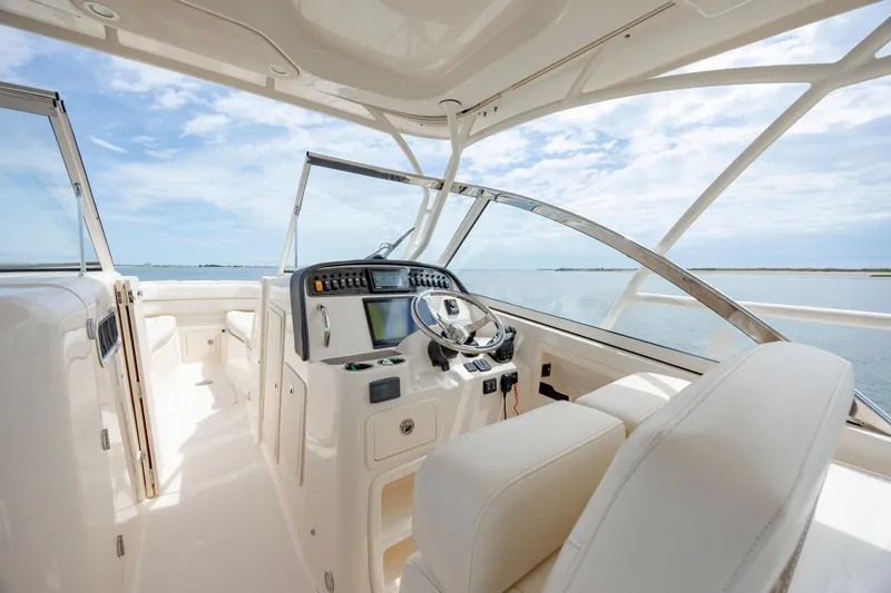 Slide: The Image of 2020 Grady-White Freedom 307 boat interior with modern helm and ocean view. - 15