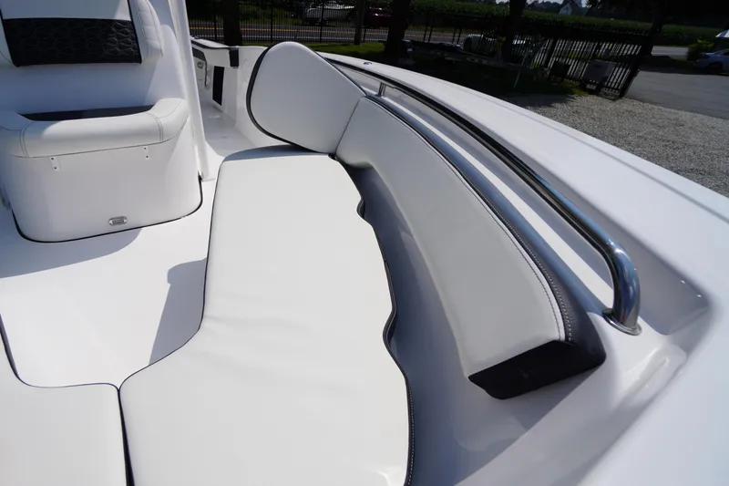 Slide: The Image of 2026 Tidewater 198 CC Adventure boat interior with white cushioned seating and stainless steel railing. - 10