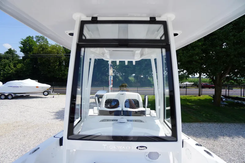 Slide: The Image of 2026 Tidewater 198 CC Adventure boat, front view, parked outdoors. - 16