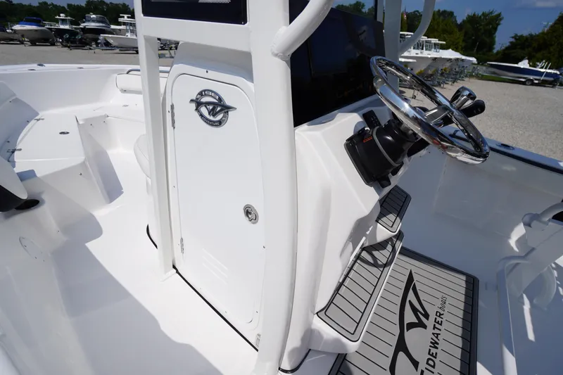 Slide: The Image of 2026 Tidewater 198 CC Adventure boat interior with steering wheel and console details. - 18