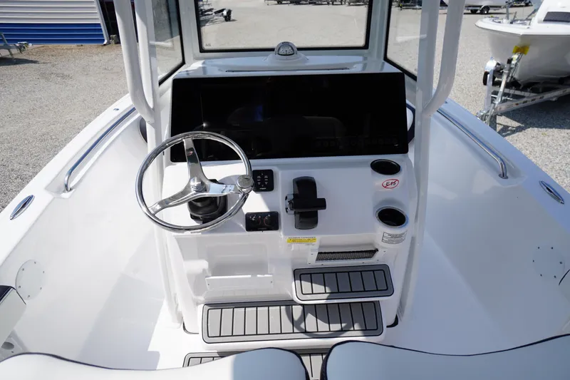 Slide: The Image of 2026 Tidewater 198 CC Adventure boat console with steering wheel and controls. - 22