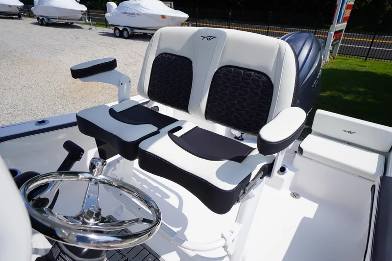 Slide: The Image of 2026 Tidewater 198 CC Adventure boat interior with dual seats and steering wheel. - 25