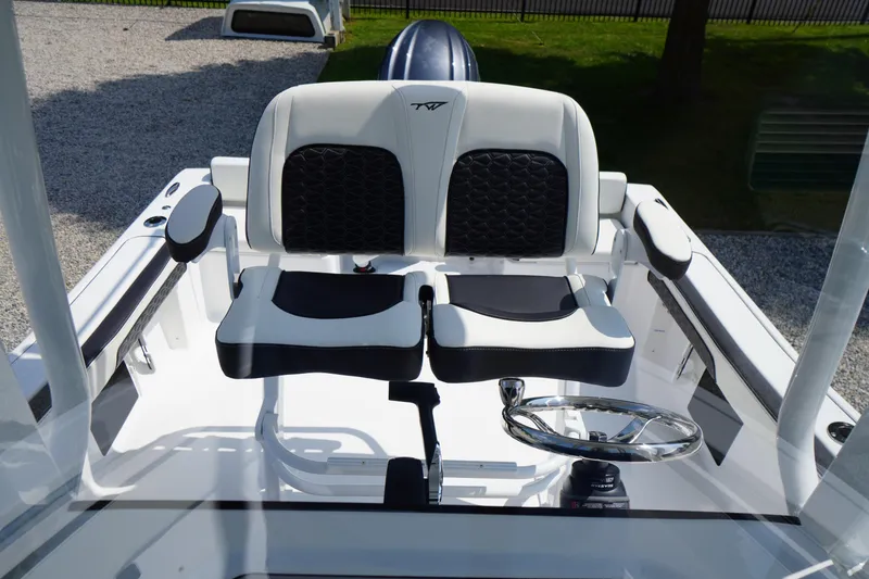 Slide: The Image of 2026 Tidewater 198 CC Adventure boat helm with dual seats and steering wheel. - 26
