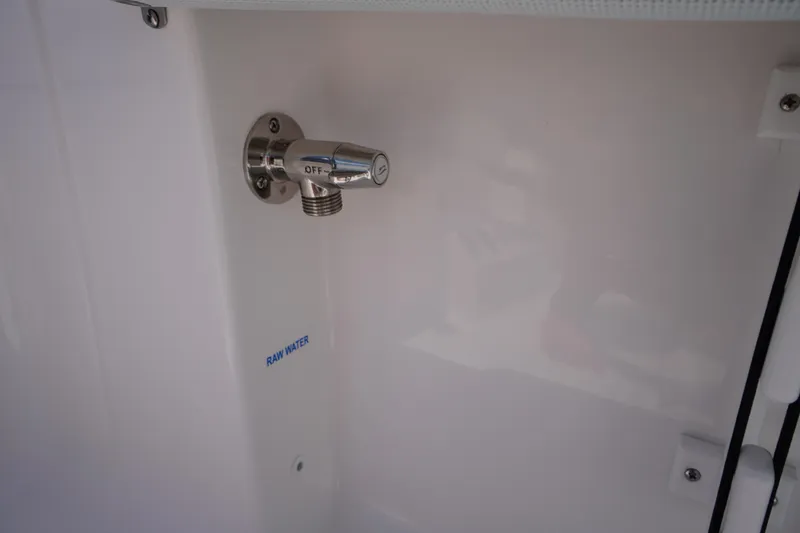 Slide: The Image of 2026 Tidewater 198 CC Adventure boat raw water outlet with off switch. - 33