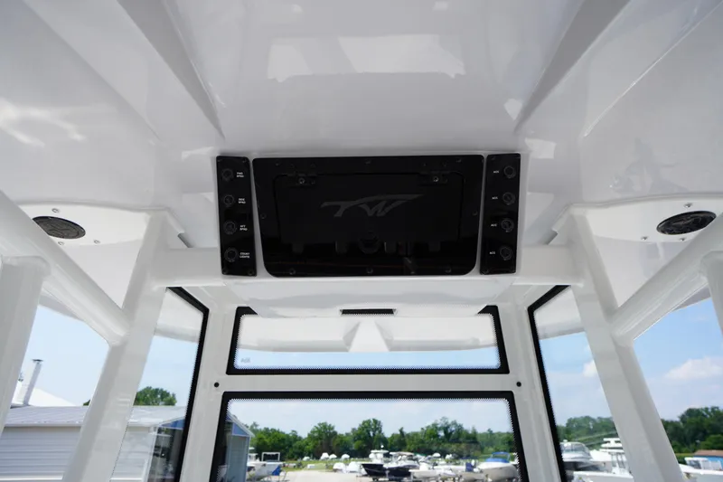 Slide: The Image of 2026 Tidewater 198 CC Adventure boat interior, featuring control panel and windows. - 44