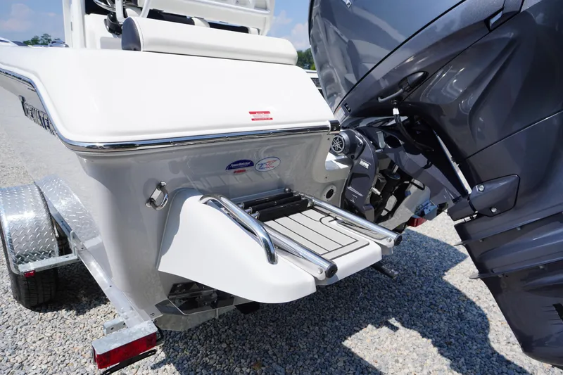 Slide: The Image of 2026 Tidewater 198 CC Adventure boat with motor and swim platform on a trailer. - 49