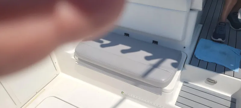 Slide: The Image of Interior of a 2015 Century 30 boat, featuring seating and deck details. - 10