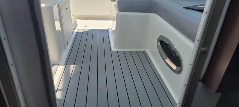 Slide: The Image of Interior view of a 2015 Century 30 boat with sleek seating and modern flooring. - 12