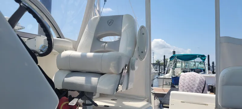 Slide: The Image of Captain's chair on a 2015 Century 30 boat, docked under a clear blue sky. - 16