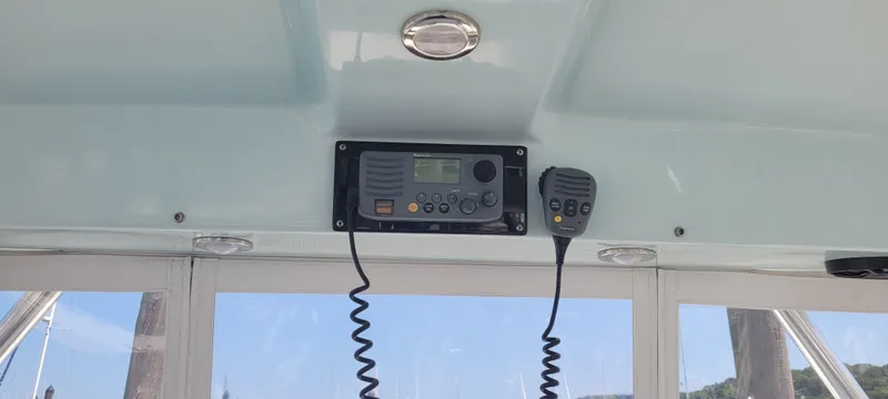 Slide: The Image of Boat interior with radio system, Century 30, 2015 model, featuring a microphone and control panel. - 20