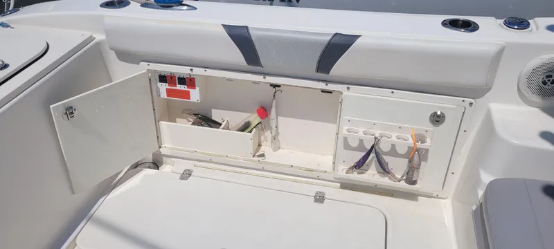 Slide: The Image of Storage compartment on a 2015 Century 30 boat, featuring tools and accessories. - 25
