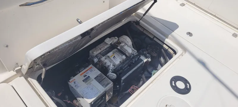 Slide: The Image of Open engine compartment of a 2015 Century 30 boat, showcasing internal components. - 26
