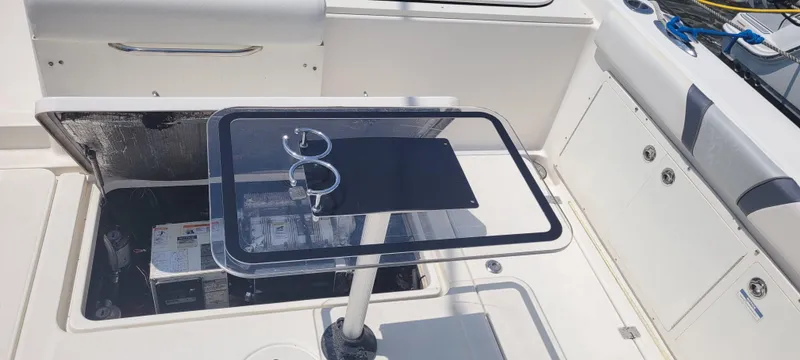 Slide: The Image of 2015 Century 30 boat interior with open hatch and table setup. - 27
