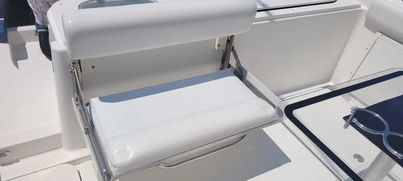 Slide: The Image of White seating on a 2015 Century 30 boat, featuring sleek design and modern fixtures. - 28