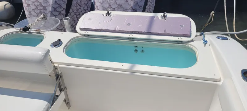 Slide: The Image of Century 30 boat livewell, 2015 model, open lid, turquoise water, docked. - 29