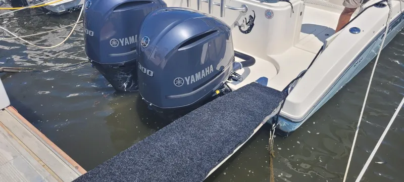 Slide: The Image of Century 30 boat with dual Yamaha engines docked, featuring a carpeted ramp. - 30