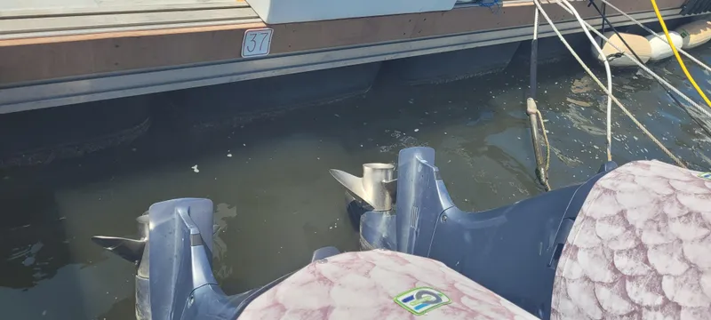 Slide: The Image of Twin outboard motors on a 2015 Century 30 boat docked at slip 37. - 32