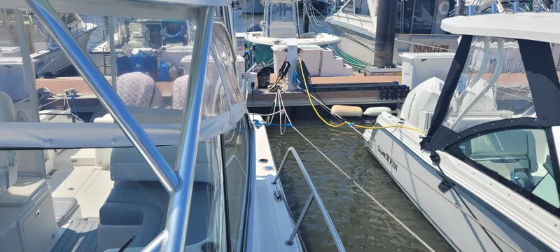 Slide: The Image of Boats docked at a marina, featuring a 2015 Century 30 model. - 33