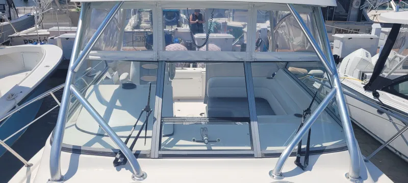 Slide: The Image of Century 30 boat, 2015 model, docked with clear windows and sleek design. - 35
