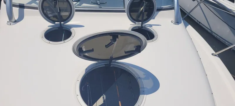 Slide: The Image of 2015 Century 30 boat deck with open hatches and railings. - 37