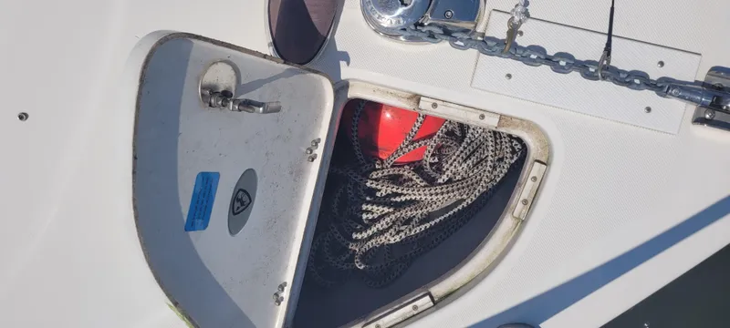 Slide: The Image of Open storage compartment on 2015 Century 30 boat with rope and red buoy. - 38
