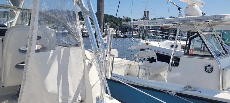 Slide: The Image of Century 30 boat, 2015 model, docked at marina with clear skies and surrounding vessels. - 41