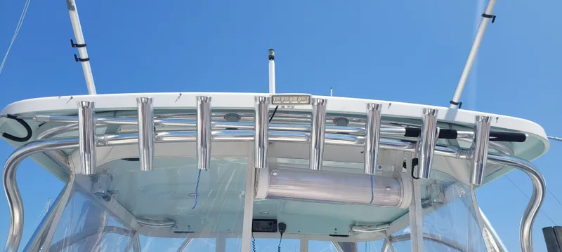 Slide: The Image of Century 30 boat, 2015 model, featuring rod holders and a clear canopy against a blue sky. - 42